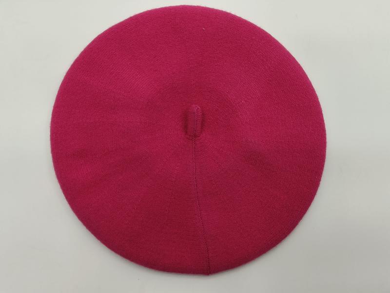 `Roze gebreide wollen baret met centrale knoop