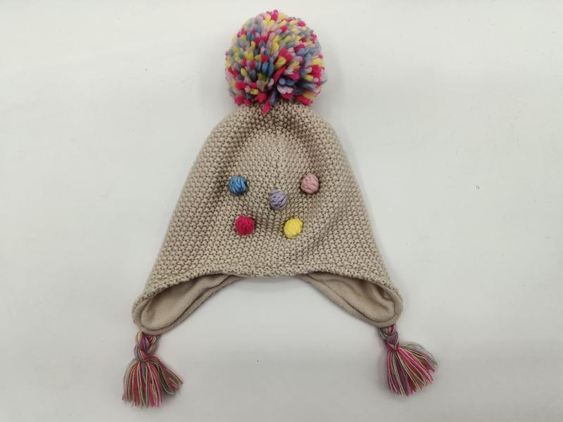 `Beige gebreide wintermuts voor kinderen met kleurrijke pompon en kwastjes`