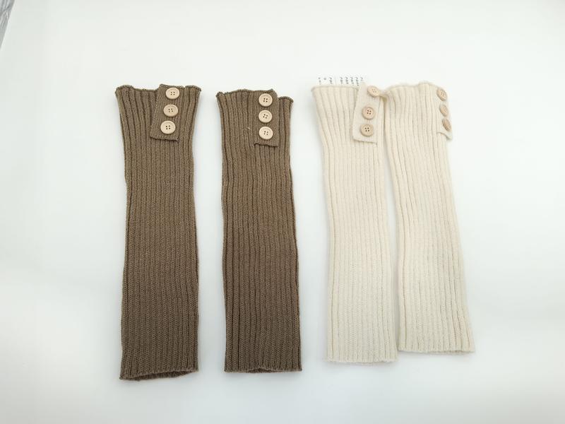 Twee paar geribbelde gebreide beenwarmers met houten knopen