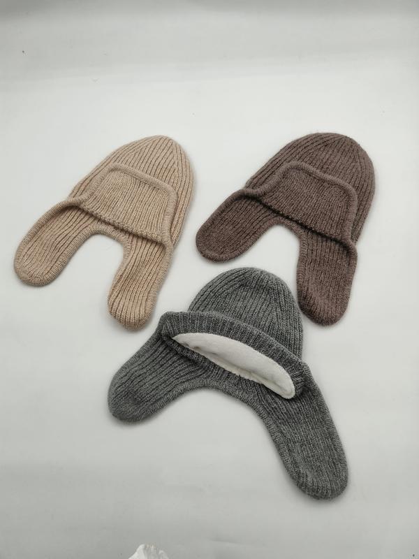 Drie geribbelde gebreide mutsen met oorkleppen in beige