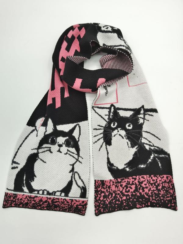 `Gebreide wintersjaal met zwart-witte smoking katten en roze geometrische patronen op witte achtergrond.`
